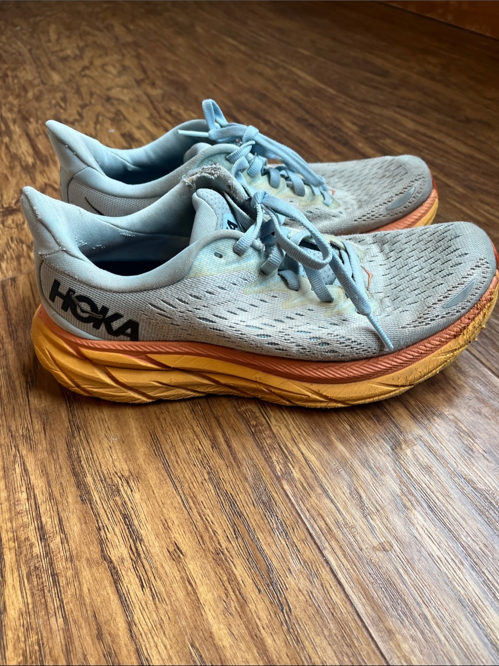 Hoka Women's Light Blue Running Shoes with Orange and Yellow Midsole